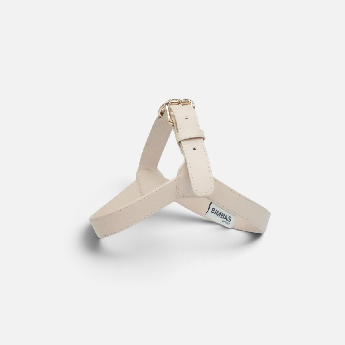 Arnés para perros BIMBAS BRAND en piel sintética beige con hebilla dorada y diseño cómodo para paseos elegantes.