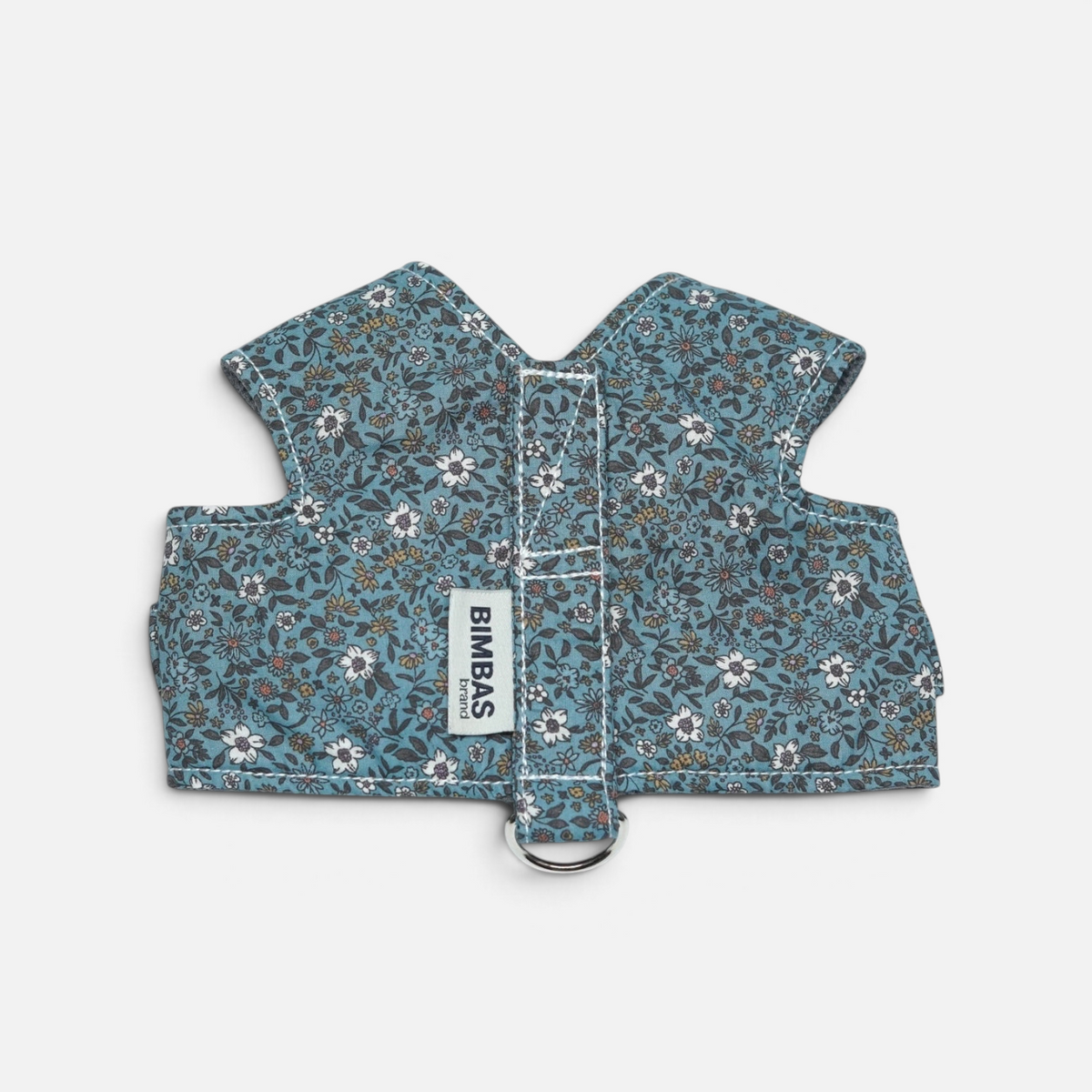 Arnés chaleco BIMBAS BRAND de algodón azul con estampado floral, malla transpirable y cierres metálicos ajustables.